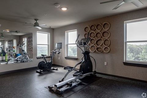 A spacious home gym with a variety of exercise equipment.