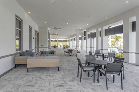 A spacious room with a long table and chairs.
