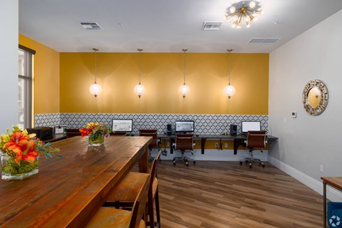 A conference room with a long table and chairs.