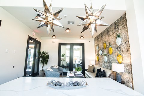 A living room with a white couch and a star-shaped light fixture.