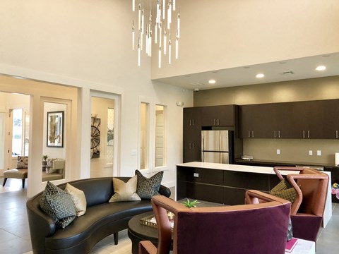 A modern living room with a black couch and a brown chair.