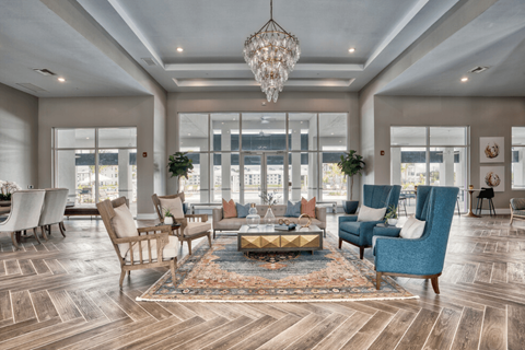 a living room with couches and chairs and a chandelier