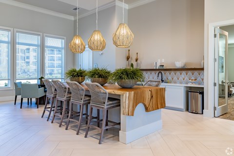 A kitchen with a table and chairs.