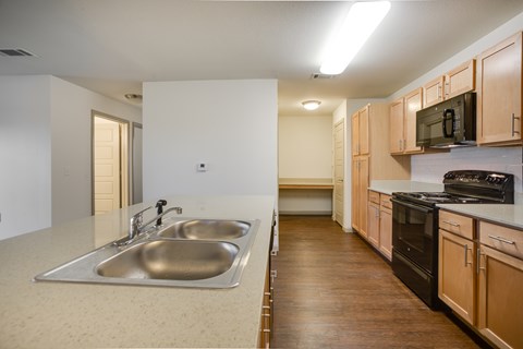 A kitchen with a sink and a stove.