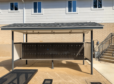 A black and white outdoor table with a black umbrella.