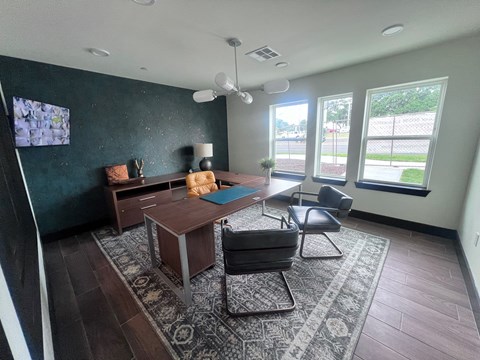 A living room with a dark green wall and a television mounted on it.