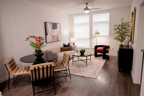 A living room with a round table and chairs.