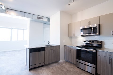 A modern kitchen with a stainless steel oven and microwave.