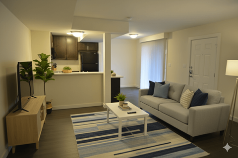A living room with a white couch and a coffee table.