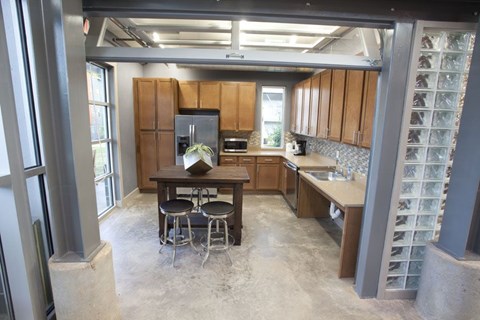 A kitchen with a table and chairs in the middle of the room.