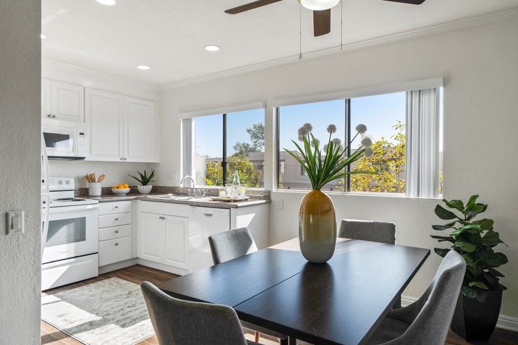 an open kitchen and dining room with a table and chairs