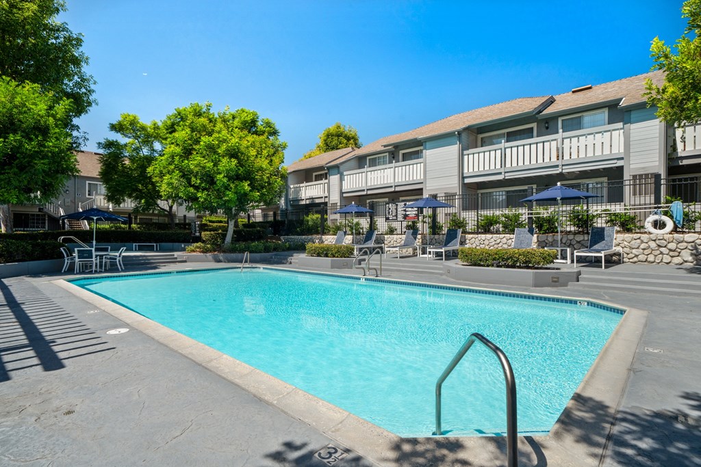 a swimming pool with a building in the background