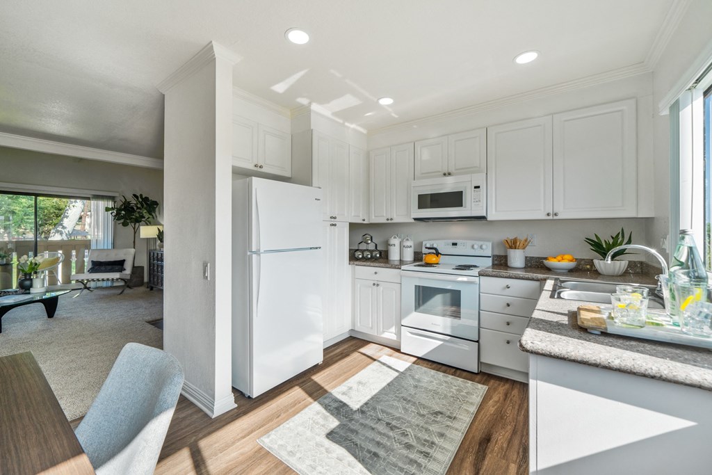 a white kitchen with white appliances and white cabinets
