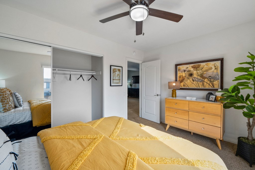 a bedroom with a bed and a ceiling fan