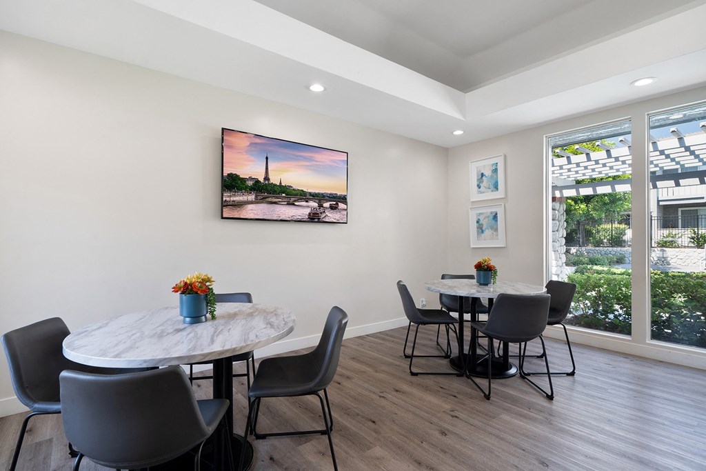 a dining room with a table and chairs and a large window
