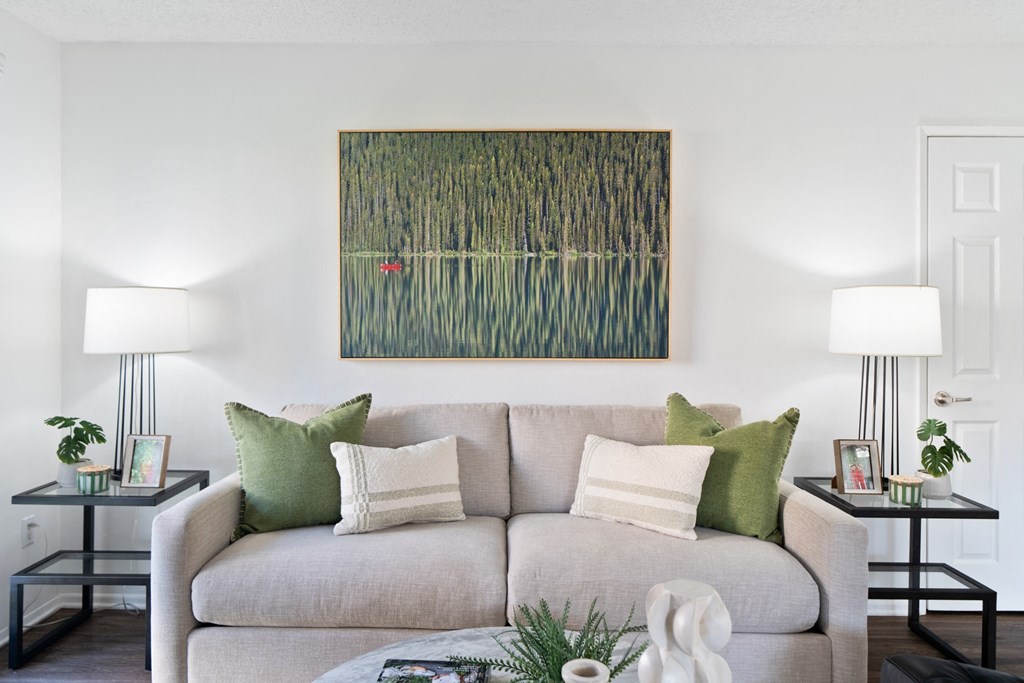 a living room with a couch and a table with lamps