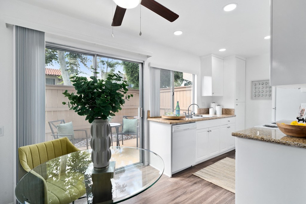 a kitchen and dining room with a glass table