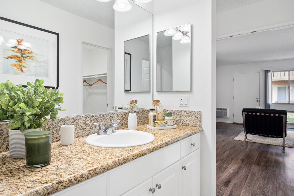 a bathroom with sinks and mirrors on the wall