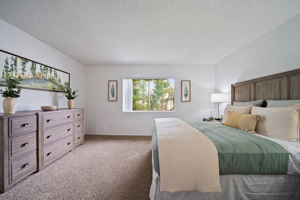 a bedroom with a bed and a dresser