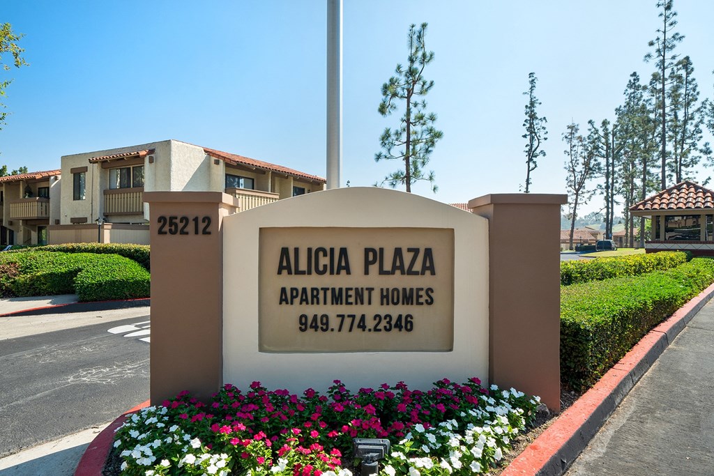 a sign for alisal plaza apartment homes in front of a building