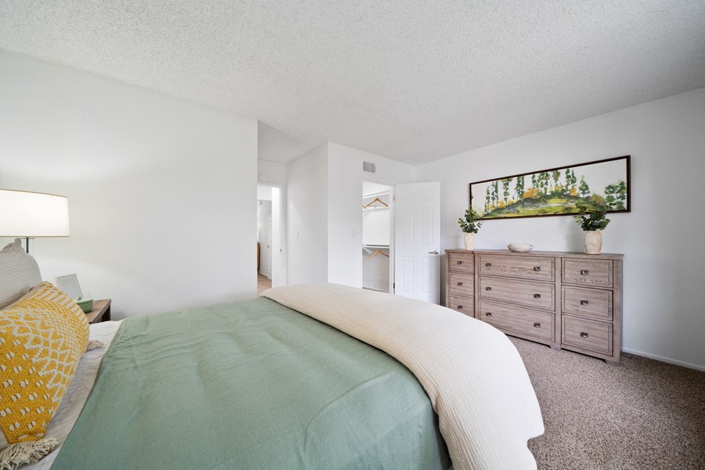 a bedroom with a bed and a dresser