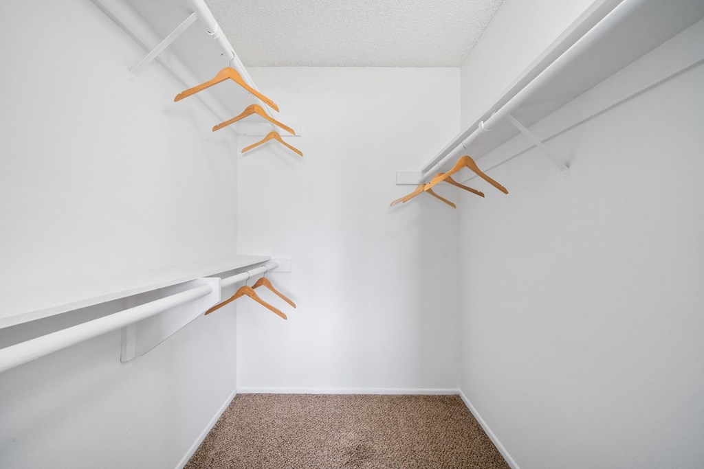a spacious walk in closet at the whispering winds apartments in pearland, tx