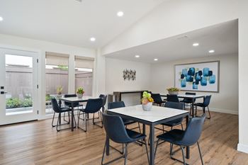 a dining room with a table and chairs