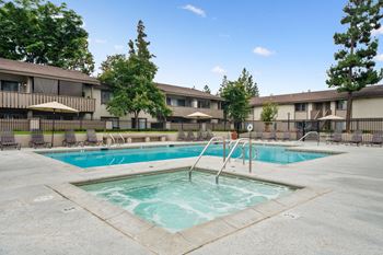 a swimming pool in a building with umbrellas