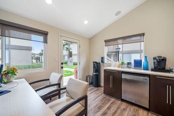 a kitchen and dining room with a table and chairs