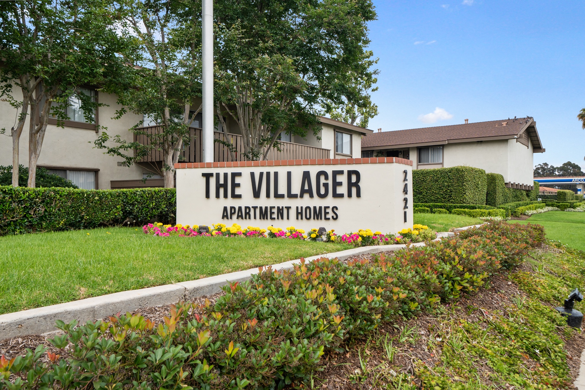 a view of the village apartments sign