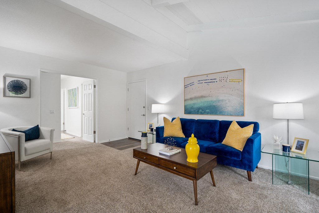 a living room with a blue couch and a coffee table