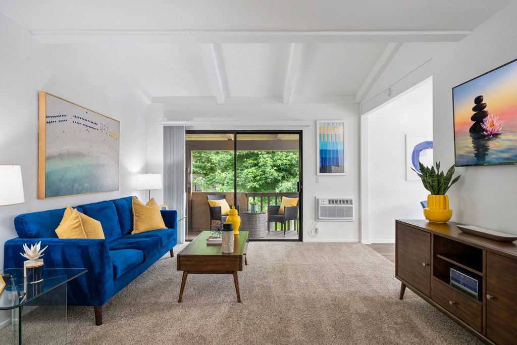 a living room with a blue couch and a coffee table
