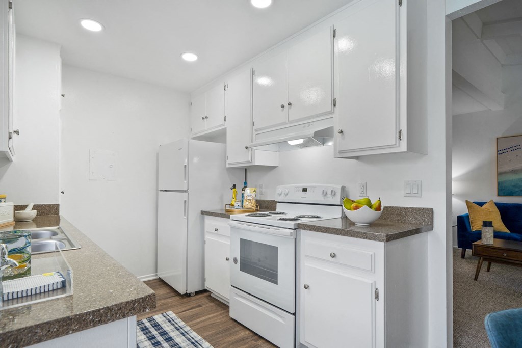 a white kitchen with white appliances and white cabinets