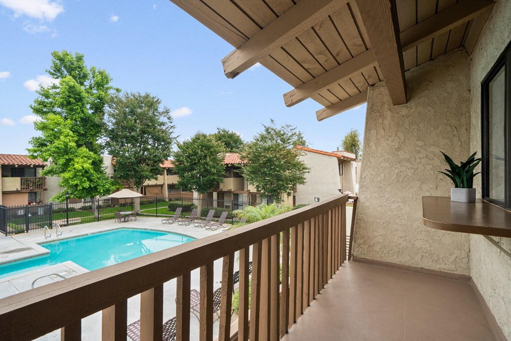 a view of a swimming pool from the balcony of a resort condo