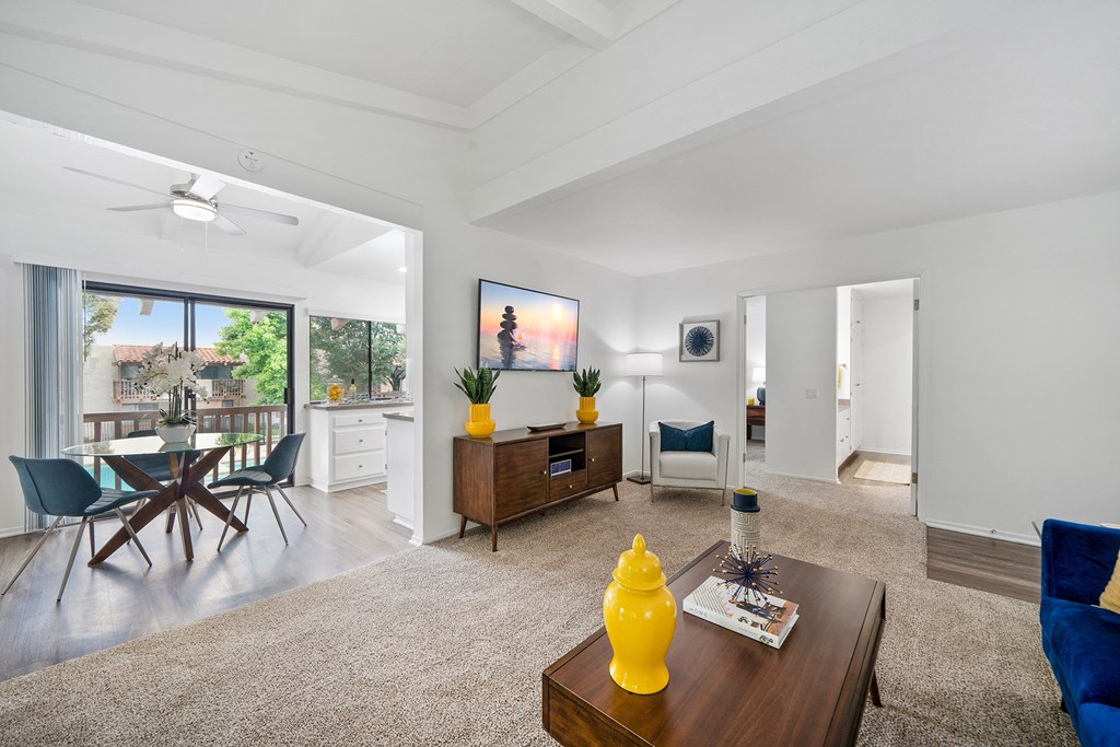 an open living room and dining room with a table and chairs