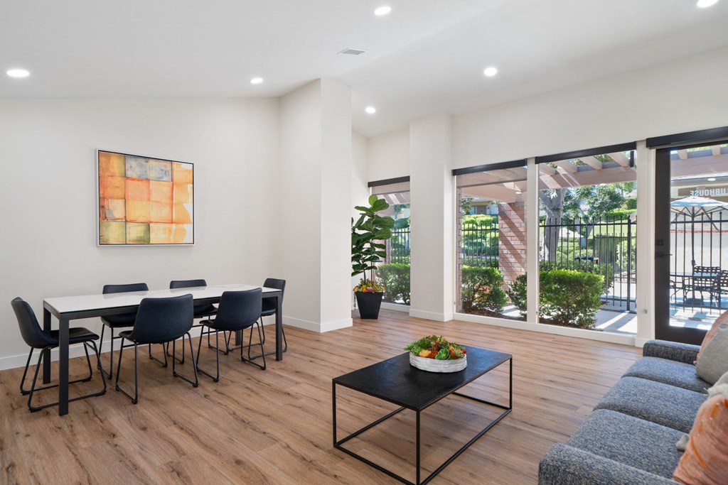 a dining room with a table and chairs and a large window