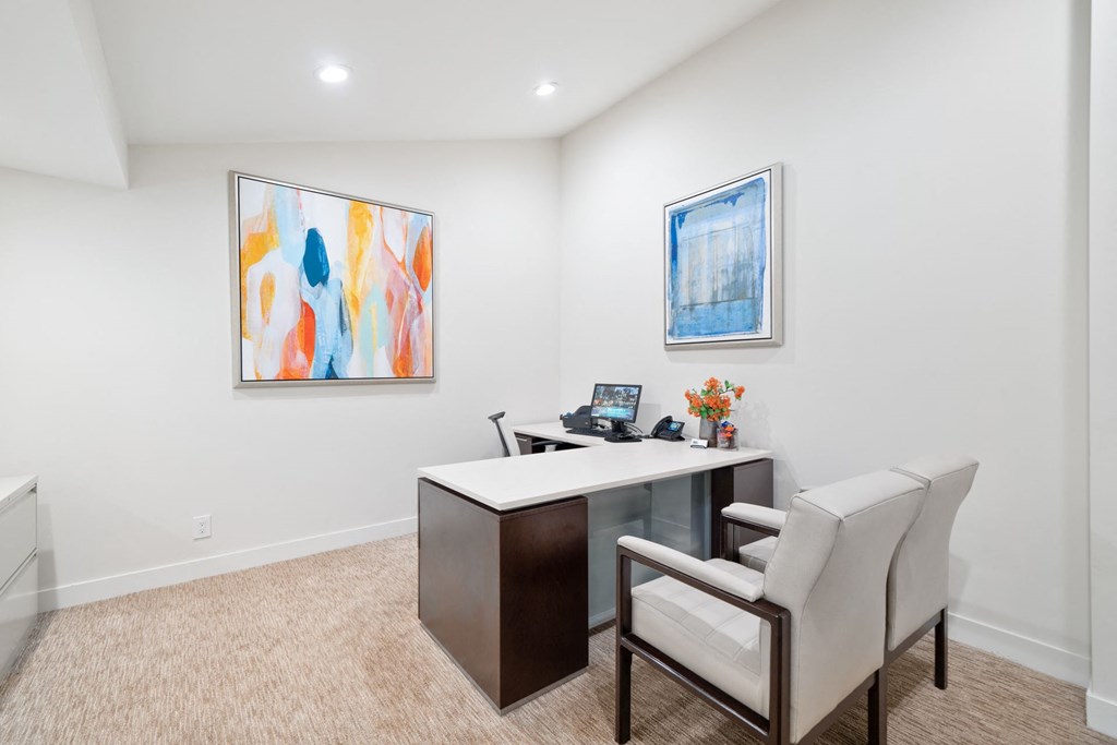 a home office with a desk and two chairs