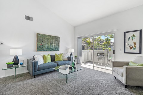 a living room with couches and a glass table