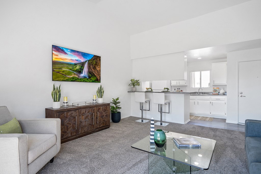a living room with a couch and a glass coffee table
