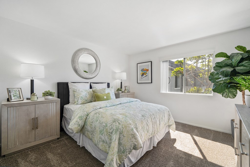 a bedroom with a bed and a window