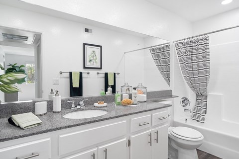 a white bathroom with a sink and a toilet