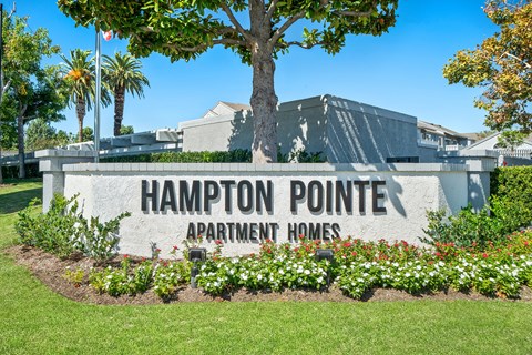 the sign for the hamppton point apartment homes entrance in front of a building