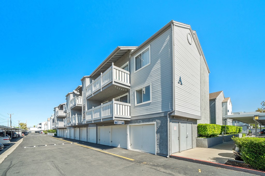 a row of apartment buildings with balconies and garages