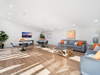 a living room with couches and chairs and a dining room table