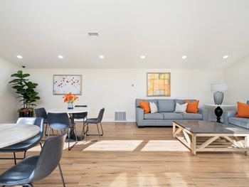 a living room with a couch and a table and chairs