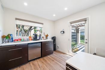 a kitchen with a counter and a door to a patio