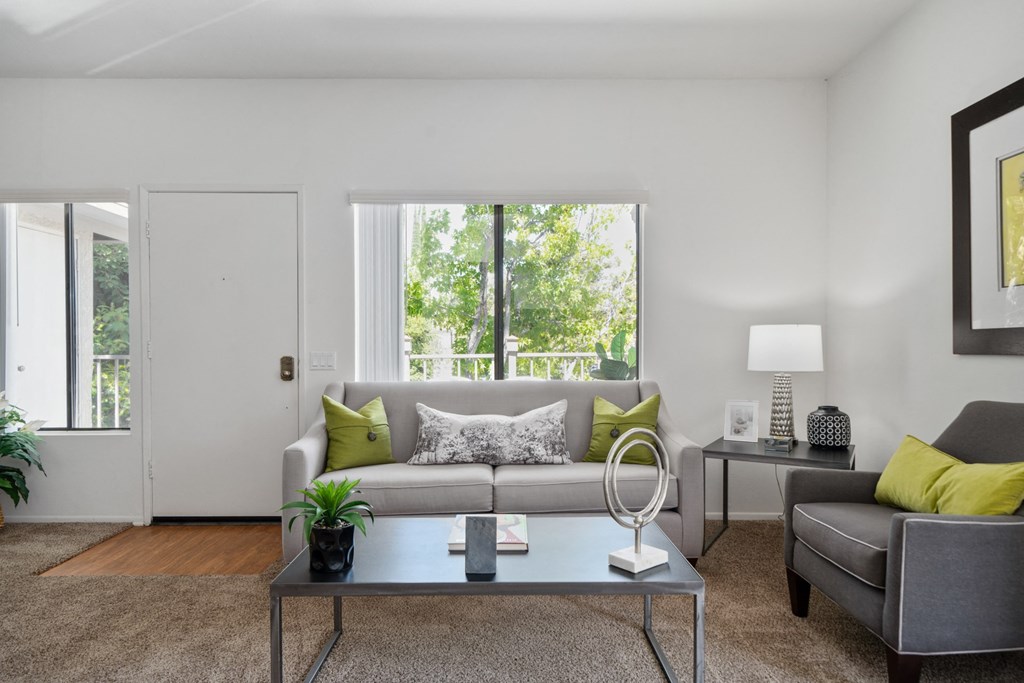 a living room with a couch coffee table and a window