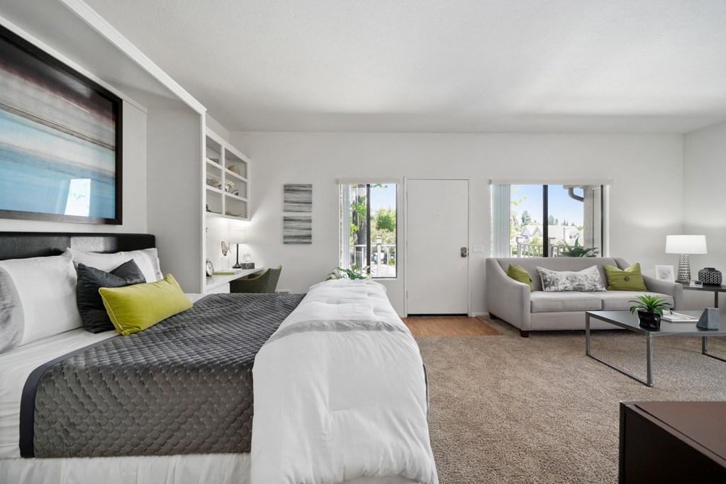 a bedroom with a bed and a couch in a 555 waverly unit