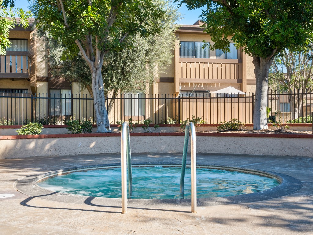 a small swimming pool in front of an apartment building