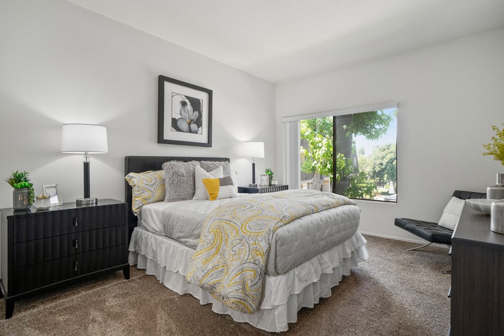 a bedroom with a large bed and a large window
